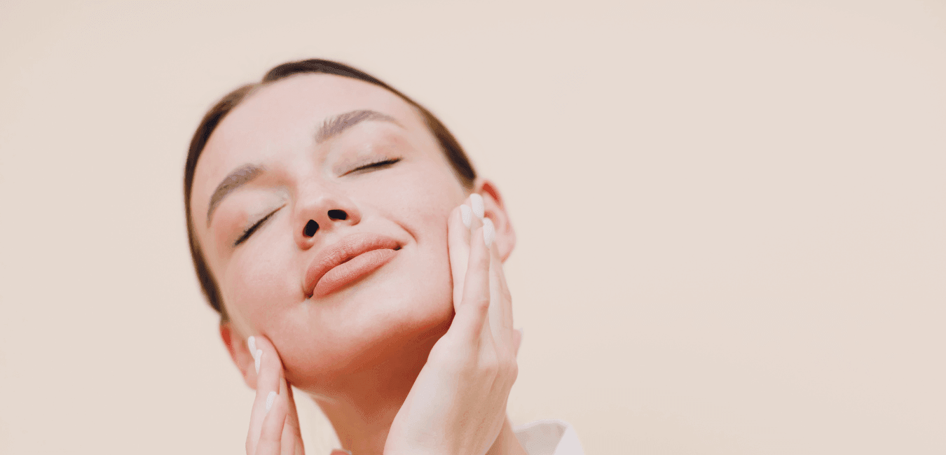 Woman misting face with natural Moroccan rose water